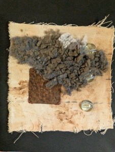 Shrine #1
Abstract textile art piece featuring textured fabric, grey wool, a rusted metal piece, and glass beads on a beige canvas.